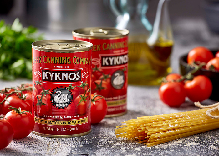 Cans with cherry tomatoes in tomato juice next to pasta.